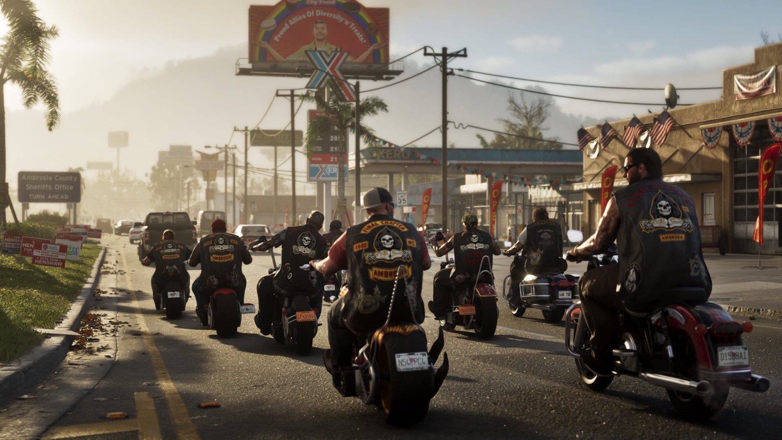 A column of motorcycles riding down a two-lane strip past low storefronts at Ambrosia, hills behind